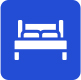 A white bed icon on a blue background indicating a hotel or lodging.